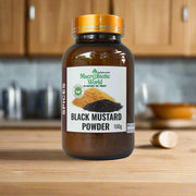 Jar of black mustard powder with a label on a gray background