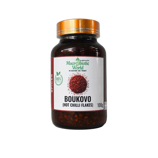 Jar of Boukovo hot chili flakes with a gold lid on a gray background