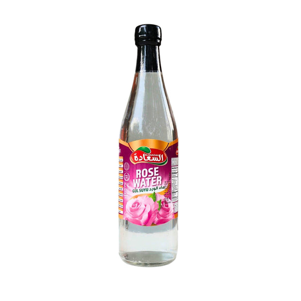 Bottle of rose water with a label on a white surface and gray background