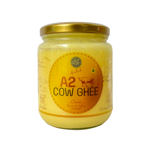 Jar of A2 Cow Ghee with a gold lid on a white background