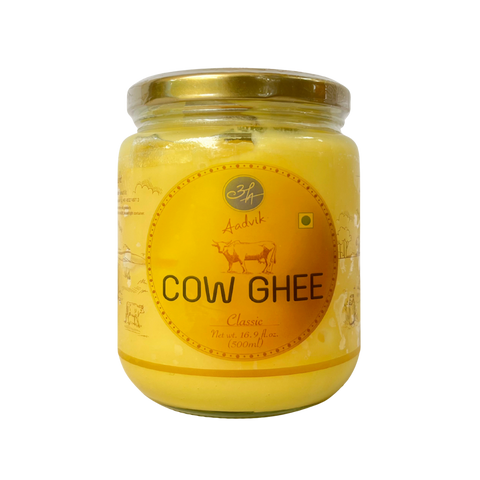 Jar of cow ghee with a yellow label on a white background