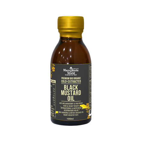 Bottle of black mustard oil with a yellow cap on a white background