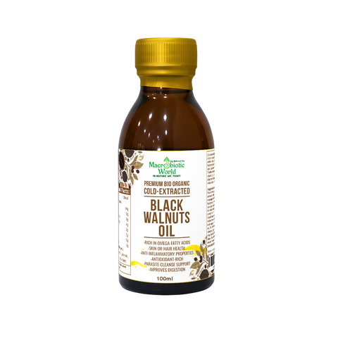 Bottle of black walnuts oil with a yellow cap on a white background