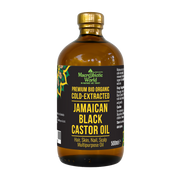 Bottle of Jamaican Black Castor Oil with a gold cap on a white background