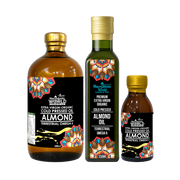 Three bottles of Macrotropic World almond oil with colorful labels on a white background
