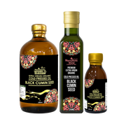 Three bottles of Macchie World Black Cumin Seed oil on a white background