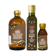Three bottles of Macchie World walnut oil on a white background