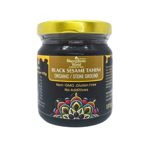 Jar of Black Sesame Tahini with a gold lid on a white background