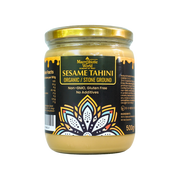 Jar of organic sesame tahini with a decorative label on a white background