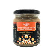 Jar of sweet apricot butter with a black lid on a white background