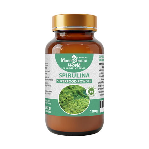 Spirulina superfood powder bottle with a gold cap on a white background