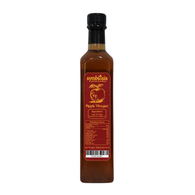 Bottle of Symbiosis apple vinegar on a white background