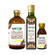 Three bottles of Symbiosis Almond Oil on a white background