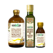 Three bottles of Symbiosis walnut oil on a white background