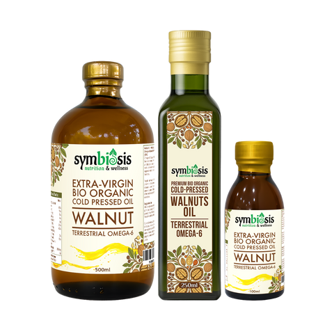 Three bottles of Symbiosis walnut oil on a white background