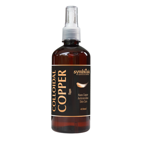 Bottle of colloidal copper solution with a spray nozzle on a white background